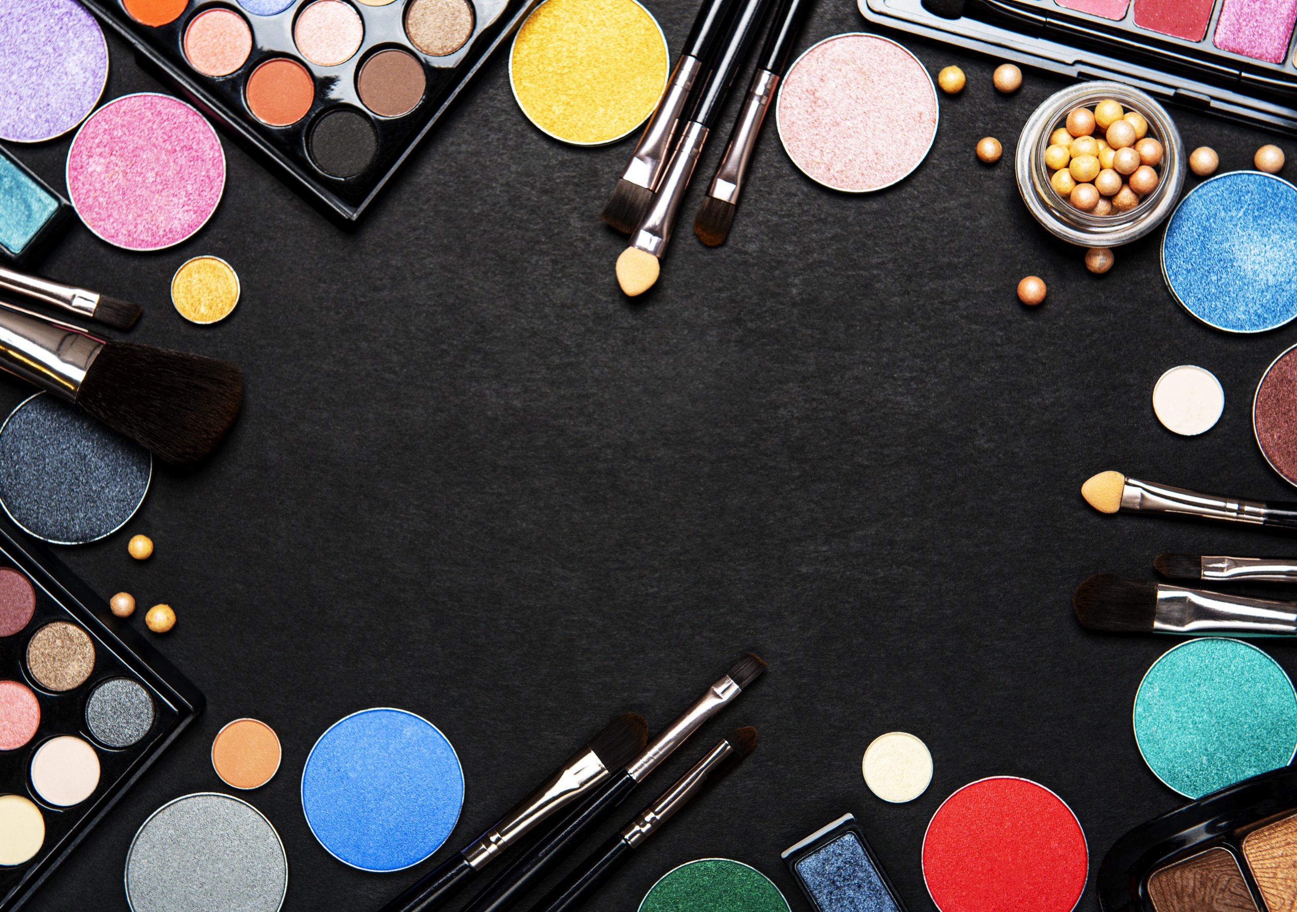 Set of decorative cosmetics on a black background. Flat lay, top view.